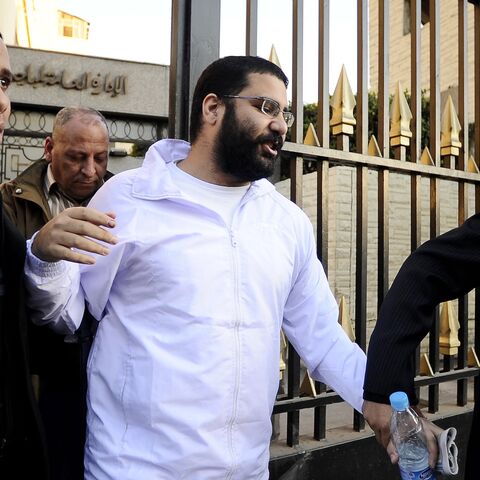 Egyptian blogger and activist Alaa Abdel-Fattah exits the police headquarters in Cairo following his release on December 25, 2011.