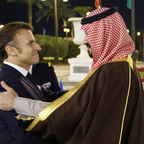 TOPSHOT - French President Emmanuel Macron is welcomed by Saudi's Crown Prince Mohammed Bin Salman ahead of their meeting in Riyadh on December 2, 2024. Macron touched down in Riyadh, the capital of the oil-rich Gulf kingdom, where he was due to hold talks with de facto ruler Crown Prince Mohammed bin Salman later on December 2, an AFP journalist said. (Photo by Ludovic MARIN / POOL / AFP) (Photo by LUDOVIC MARIN/POOL/AFP via Getty Images)
