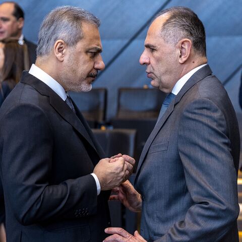 Giorgos Gerapetritis (L), foreign minister of Greece, speaks with Hakan Fidan (R), foreign minister of Turkey during the second meeting of North Atlantic Council of foreign ministers at NATO headquarters, Brussels, Dec. 4, 2024.