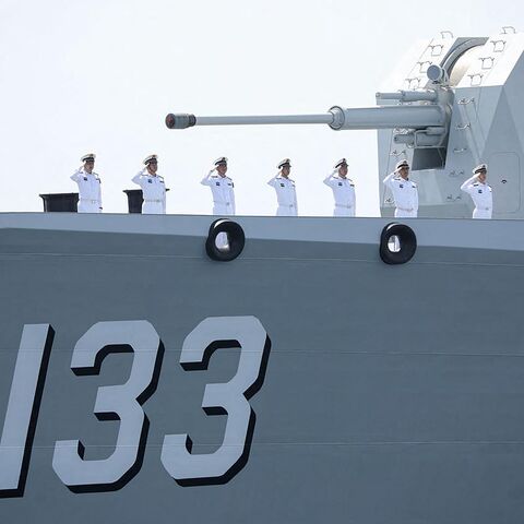 This handout photo made available by the Iranian Army Office on March 12, 2025, shows navy personnel saluting aboard a Chinese military ship during a joint Iranian-Russian-Chinese drill in the Gulf of Oman. 