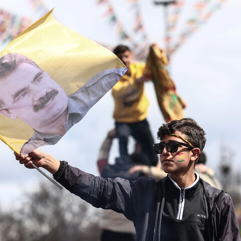 Kurdish youths holds a poster of jailed PKK militant group leader Abdullah Ocalan during Newroz celebrations, Diyarbakir, Turkey, March 21, 2025.