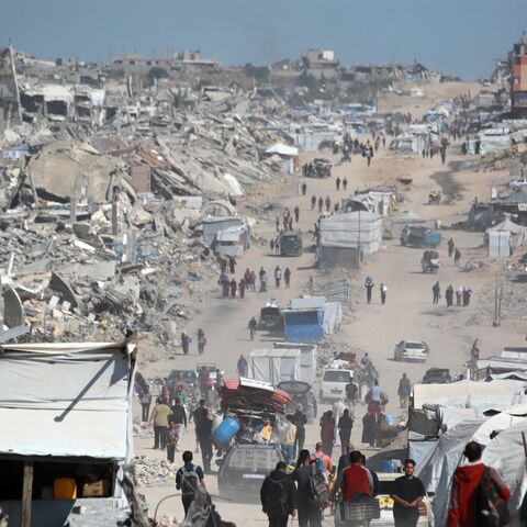 Palestinians carry their belongings as they flee Gaza City, May 16, 2025. 
