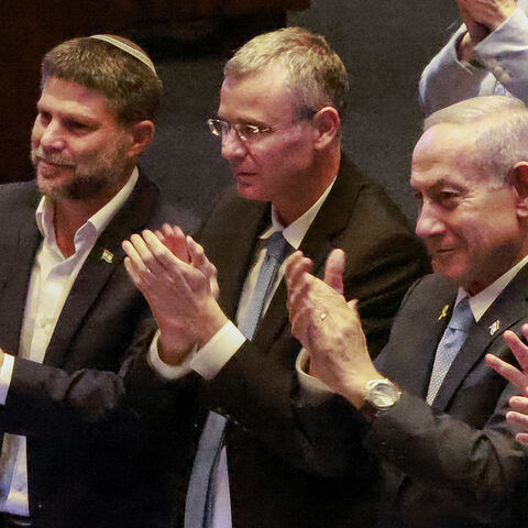 Israel's (L to R) Finance Minister Bezalel Smotrich, Justice Minister Yariv Levin, and Prime Minister Benjamin Netanyahu applaud during the address of Argentina's President to a session of the Israeli parliament (Knesset) at its headquarters in Jerusalem on June 11, 2025. (Photo by Menahem KAHANA / AFP) (Photo by MENAHEM KAHANA/AFP via Getty Images)