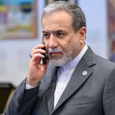 Iranian Foreign Minister Abbas Araghchi talks on his mobile phone ahead the family photo during the 51st session of the Council of Foreign Ministers of the Organization of Islamic Cooperation (OIC) in Istanbul, on June 21, 2025. 