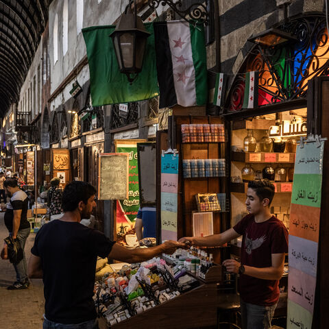 People shop in a market on June 17, 2025 in Damascus, Syria. 