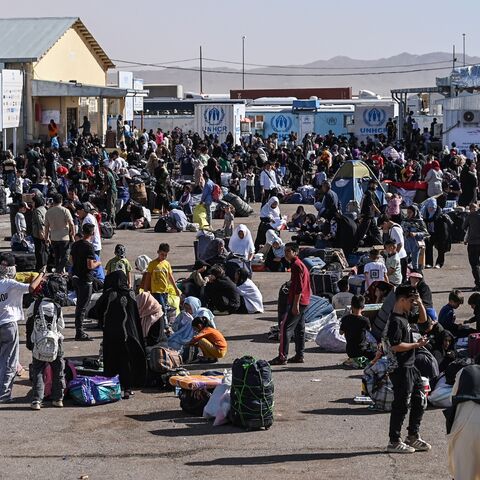 Afghan refugees are pictured at the Islam Qala border crossing between Afghanistan and Iran on June 28, 2025, following their deportation from Iran.
