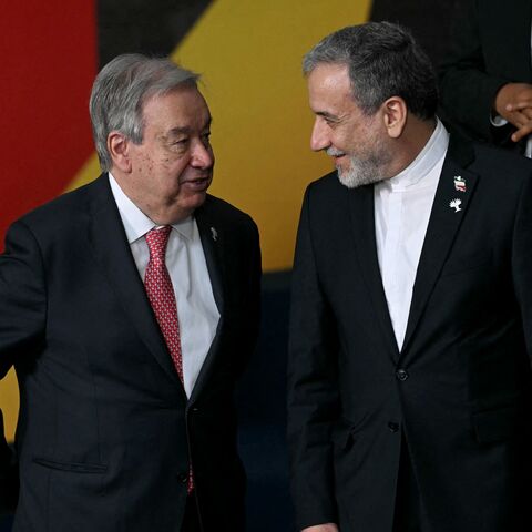 United Nations Secretary-General Antonio Guterres (L) and Iran's Foreign Minister Abbas Araghchi talk.