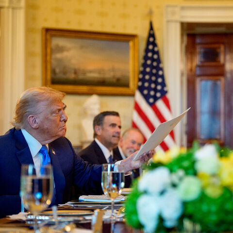 Israeli Prime Minister Benjamin Netanyahu (R) holds the letter he sent to the Nobel Peace Prize committee to nominate US President Donald Trump (L) for the Nobel Peace Prize during a dinner in the Blue Room of the White House, Washington, July 7, 2025.