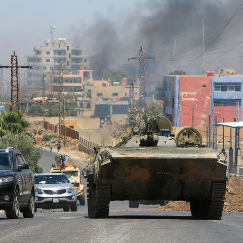 Members of Syria's security forces drive through the predominantly Druze city of Suwayda on July 15, 2025, following Israeli bombardment amid clashes between Bedouin tribes and Druze fighters.