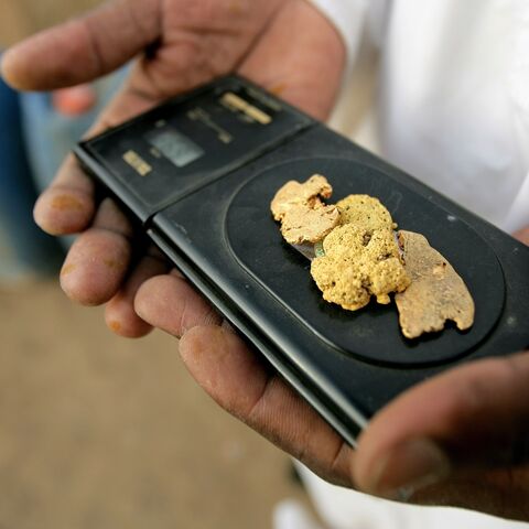 A Sudanese merchant weighs pure gold on an electronic scale in the village of al-Shirik in northern Sudan on Aug. 8, 2010.