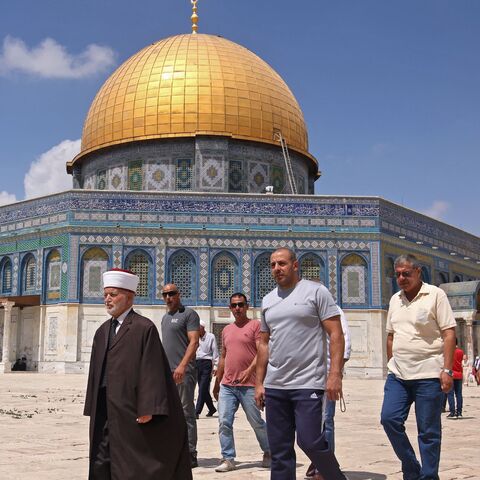 Muhammad Ahmad Hussein (L), the Grand Mufti of Jerusalem, walks in front of the Dome of the Rock mosque following Friday prayers in Jerusalem's al-Aqsa mosque complex, on September 10, 2021.