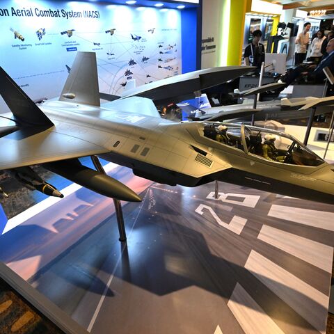 Participants look at a miniature of KF-21 fighter jet (front) on display at the Responsible AI in the Military Domain (REAIM) summit in Seoul on Sept. 10, 2024. 