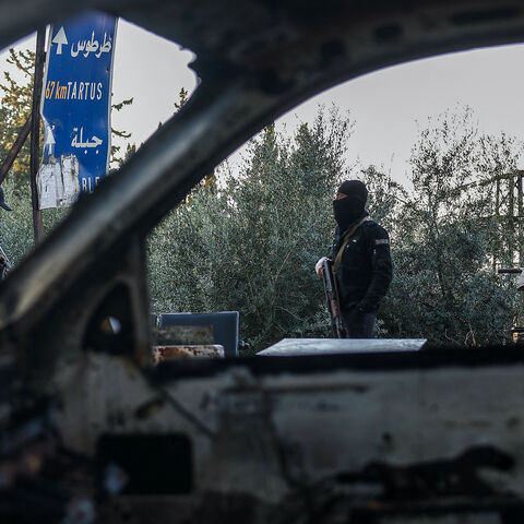Security forces loyal to the interim Syrian government stand guard at a checkpoint previously held by supporters of deposed president Bashar al-Assad, in the town of Hmeimim, in the coastal province of Latakia, on March 11, 2025.  