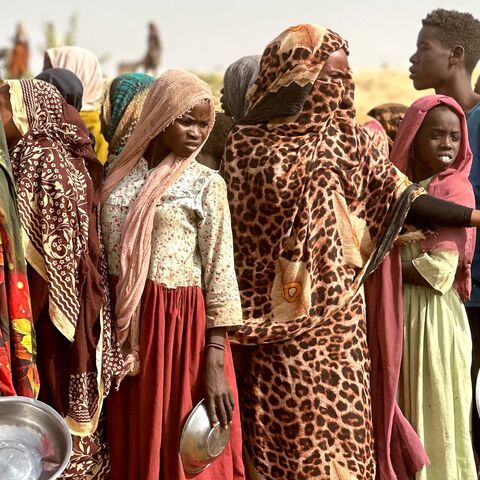 People who fled the Zamzam camp for the internally displaced after it fell under RSF control queue for food rations in a makeshift encampment in an open field near the town of Tawila in Sudan's western Darfur region on April 13, 2025.