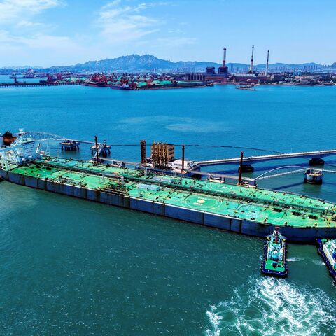 A ship loaded with oil docks at a pier with the help of a tugboat at the port of Qingdao, in eastern China's Shandong province on June 12, 2025.