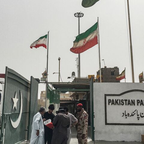 Pakistani security personnel check the documents of people who came from Iran at the Pakistan-Iran border in Taftan on June 16, 2025.