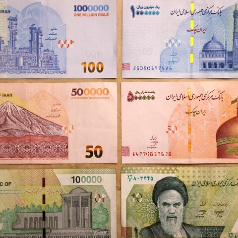 This picture shows old Iranian banknotes of 1 million, 500,000,and 100,000 rials (L), and the new banknotes with four zeros removed (R), on Aug. 3, 2025.