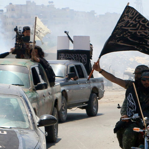 Fighters from Al-Qaeda's Syrian affiliate Al-Nusra Front drive in the northern Syrian city of Aleppo flying Islamist flags as they head to a frontline, on May 26, 2015. 
