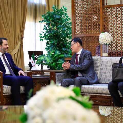 Syrian Foreign Minister Asaad al-Shibani (L) meets with Chinese ambassador to Damascus Shi Hongwei in Damascus on July 29, 2025.