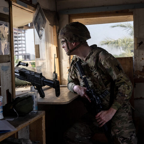 BAGHDAD, IRAQ - MAY 30: A U.S. Army soldier looks onto Baghdad from a guardhouse on the perimeter of the International Zone on May 30, 2021 in Baghdad, Iraq. Coalition forces based in Baghdad's International Zone are part of the U.S.-led Military Advisor Group of 13 nations supporting the Iraqi Security Forces. The United States currently maintains 2,500 military personnel in Iraq as part of Operation Inherent Resolve. Alpha Company 769th brigade Engineer Battalion, Louisiana National Guard is providing for