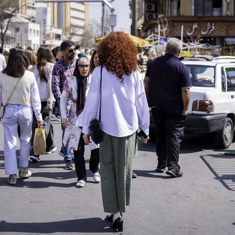 Iranian women walk on the streets, disregarding compulsory hijab law, as Iranians prepare for the Persian New Year that starts with the moment of spring equinox, on March 19, 2025, in Tajrish Square, Iran.