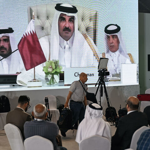 Reporters follow Qatar's Emir Sheikh Tamim bin Hamad Al-Thani's address at the media centre, during the opening of the 2025 Arab-Islamic emergency summit in Doha on Sept. 15, 2025.  