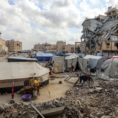 Tents sheltering Palestinians from Gaza City displaced by the Israel-Hamas conflict are pitched by damaged buildings at the Qatari-built Hamad City residential complex, northwestern Khan Yunis, southern Gaza Strip, Sept. 22, 2025.