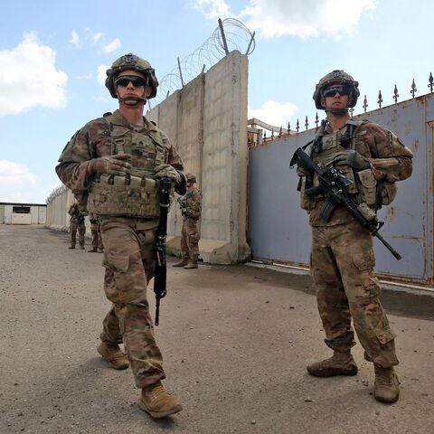 US army soldiers, part of the Combined Joint Task Force Operation Inherent Resolve (CJTF-OIR) the US-led coalition against the Islamic State (IS) group, walk around at the K1 Air Base northwest of Kirkuk in northern Iraq before a planned US pullout on March 29, 2020.