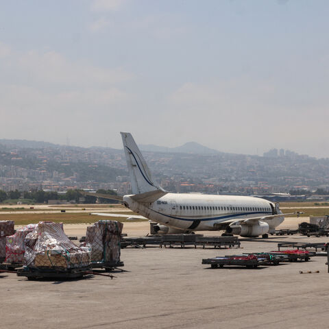 A photo taken during a tour organized by the Lebanese Ministry of Public Works and Transport shows staff loading cargo onto a plane at Beirut's international airport on June 24, 2024.