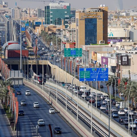 A Riyadh Metro train makes its way along a track in the middle of a road in Riyadh on December 3, 2024. 