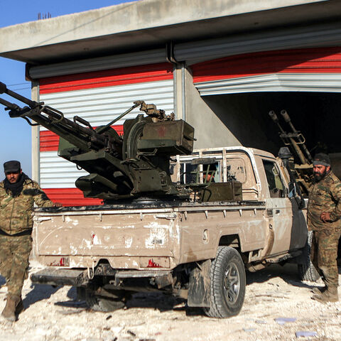 Fighters from the Turkish-backed Syrian National Army faction stand by a "technical" pickup truck at a position near the Tishrin Dam in the vicinity of Manbij, in the east of Syria's northern Aleppo province, on January 10, 2025 amidst ongoing battles with the Kurdish-led Syrian Democratic Forces (SDF).