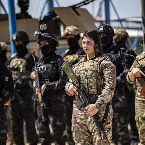 Members of the Syrian Kurdish Asayish security forces stand guard at the Kurdish-run al-Hol camp, which holds relatives of suspected Islamic State (IS) group fighters in the northeastern Hasakeh governorate, on April 18, 2025, as the Syrian Democratic Forces mount a security campaign against IS "sleeper cells" in the camp.