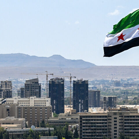 A large Syrian flag flutters above Tishreen Park in Damascus on June 4, 2025.