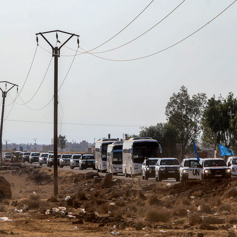 A United Nations convoy evacuating families from Sweida moves through the buffer zone in Busra al-Harir in Syria's southern Daraa province on July 22, 2025.