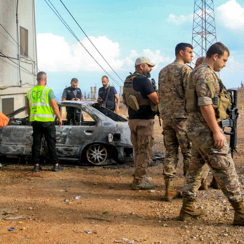 Lebanese army soldiers and security forces deploy near a vehicle that was hit by a reported drone-strike at the entrance of the village of Barja, about 30 kilometres south of Beirut, on Sept. 9, 2025. 