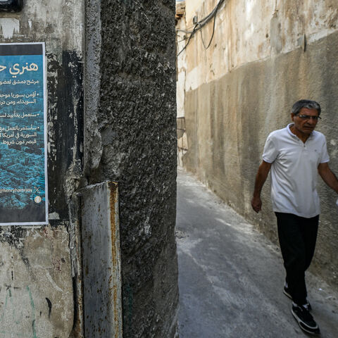 An election poster of Henry Hamra, a Syrian-American parliamentary candidate who is the son of the country's last rabbi and who if elected will be the first Jewish representative in the Syrian parliament since the late 1940s, is displayed on the entrance of the closed Jewish Maimonides School of Damascus, in the Jewish quarter of the old city of Damascus on Oct. 3, 2025, ahead of the upcoming vote on Oct. 5.