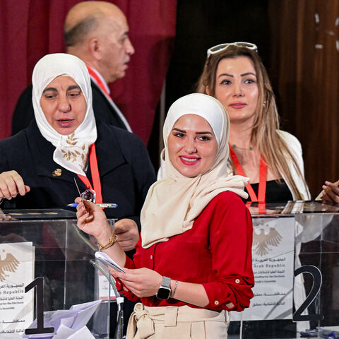 A member of Syria's local committees votes in the country's selection process to designate an interim parliament, in Damascus on Oct. 5, 2025.