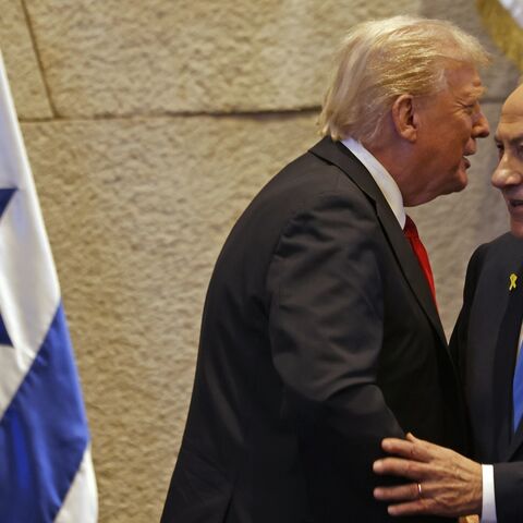 US President Donald Trump speaks with Israel's Prime Minister Benjamin Netanyahu in the Knesset, Israel's parliament, on Oct. 13, 2025, in Jerusalem.
