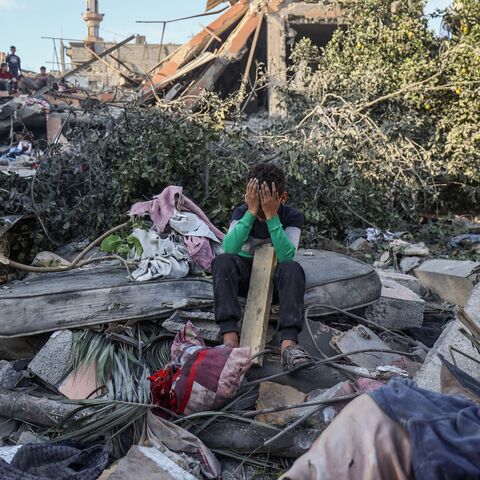 A boy reacts sitting amid the rubble of a house destroyed in an Israeli strike in Nuseirat, in the central Gaza Strip, on Oct. 29, 2025. 