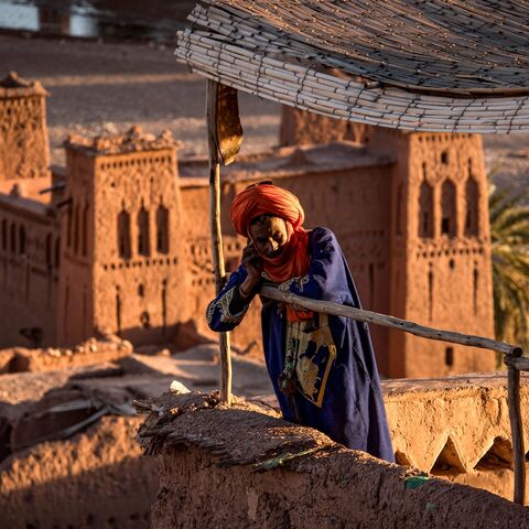 A man stands atop the kasbah of Ait-Ben-Haddou.