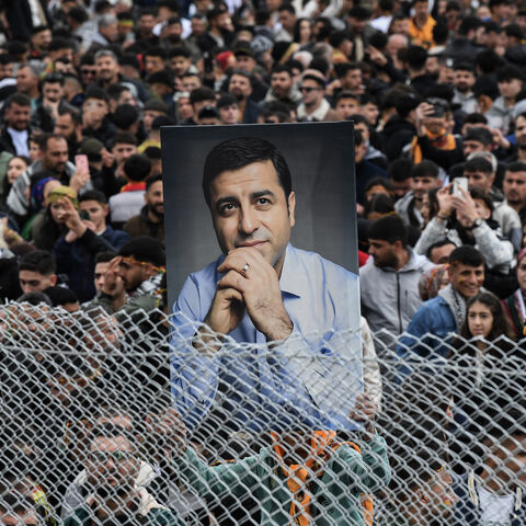 A man holds a portrait of Selahattin Demirtas during a gathering of Turkish Kurds for Nowruz celebrations marking the New Year of the Persian calendar and the first day of spring, Diyarbakir, southeastern Turkey, March 21, 2025.
