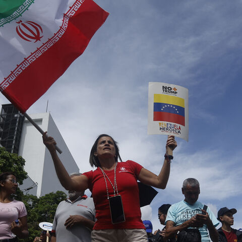A woman waves an Iranian flag during a rally against Israel's attacks on Iran, in solidarity with the Palestinian people and to call for world peace in Caracas, on June 19, 2025. 