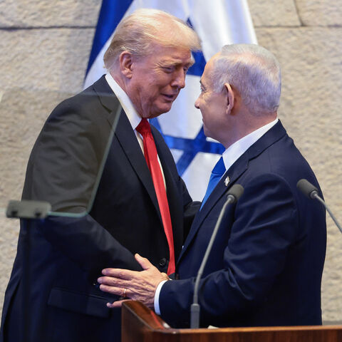 JERUSALEM - OCTOBER 13: U.S. President Donald Trump shakes hands and speaks with Israeli Prime Minister Benjamin Netanyahu at the Knesset, Israel's parliament, on the day of Trump's address on October 13, 2025 in Jerusalem. President Trump is visiting the country hours after Hamas released the remaining Israeli hostages captured on Oct. 7, 2023, part of a US-brokered ceasefire deal to end the war in Gaza. (Photo by Evelyn Hockstein - Pool/Getty Images)