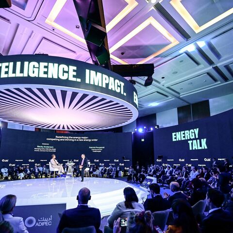 People sit listening as the Chairman and CEO of TotalEnergies Patrick Pouyanne speaks during the Abu Dhabi International Petroleum Exhibition & Conference in Abu Dhabi, on Nov. 3, 2025.