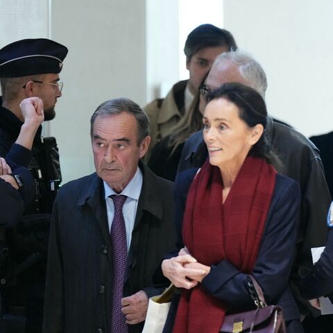 Former Director General of Lafarge Bruno Lafont (C) and French lawyer Jacqueline Laffont arrive on the opening day of the trial.