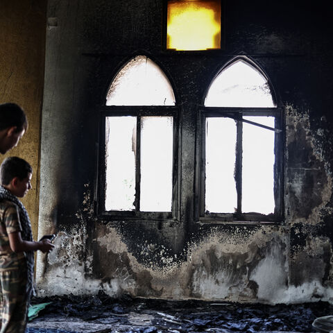 Young Palestinians look at the damage in the Hajja Hamida Mosque after it was reportedly set on fire and vandalised by Israeli settlers in the Palestinian village of Deir Istiya, near Salfit in the Israeli-occupied West Bank, on November 13, 2025. Violence in the West Bank has soared since the war in Gaza broke out in October 2023. (Photo by Zain JAAFAR / AFP) (Photo by ZAIN JAAFAR/AFP via Getty Images)