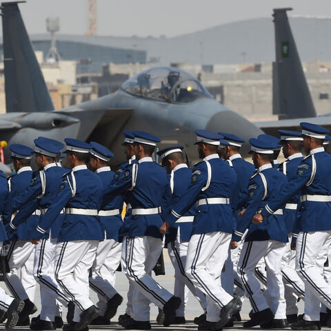 Newly graduated Saudi air force officers march in front of F-15 fighter jets during a ceremony marking the 50th anniversary of the creation of the King Faisal Air Academy at King Salman airbase in Riyadh on January 25, 2017. / AFP / FAYEZ NURELDINE (Photo credit should read FAYEZ NURELDINE/AFP via Getty Images)