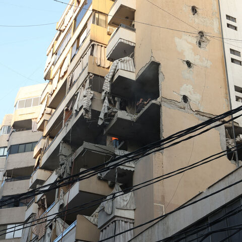 People inspect a damaged building, after Israeli military said on Sunday that it struck a militant from the Lebanese Iran-aligned Hezbollah group, in Beirut's southern suburbs, Lebanon November 23, 2025. REUTERS/Mohamed Azakir
