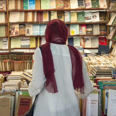 A customer browses books at a bookshop in the Moroccan capital Rabat on August 9, 2018. On the main arteries of old Rabat, dozens of itinerant booksellers offer books in French, Arabic, and sometimes in English, up to ten times cheaper than their originals. Despite being prohibited, the pirated-books market is largely tolerated in cities across the North African kingdom. (Photo by FADEL SENNA / AFP) (Photo by FADEL SENNA/AFP via Getty Images)