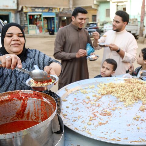 A woman sells koshary after the Eid prayer in Abu Sir village on April 21, 2023, in Giza, Egypt.